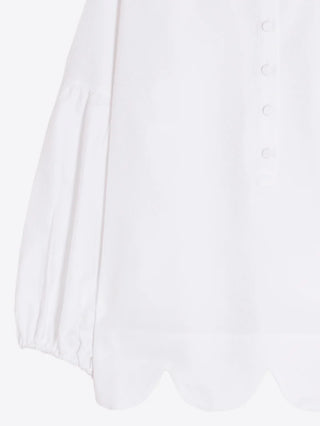 White shirt under waves