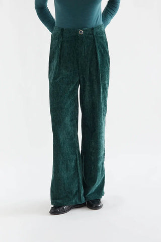 Dark green velvet trousers with a jewel button
